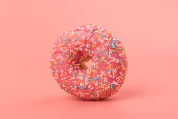 Fresh made Donuts isolated on pink background. Doughnuts are traditional sweet pastries. Copy space for text.