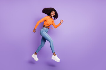 Fototapeta na wymiar Full length body size view of sporty cheerful wavy-haired girl jumping running having fun isolated over purple violet color background