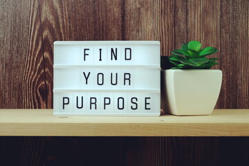Find Your Purpose word in light box on wooden background