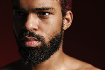 Obraz premium Black shirtless bearded man posing and looking aside