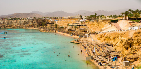 Fototapeta premium sunny panorama of ras um el sid bay in sharm el sheikh with sea, reef and beaches