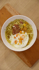 Spicy korean noodle with egg served on the table.