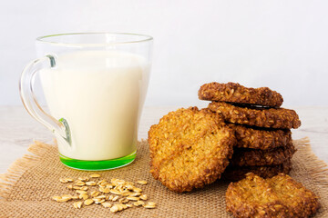 A glass of milk with oatmeal cookies for a light breakfast snack. 