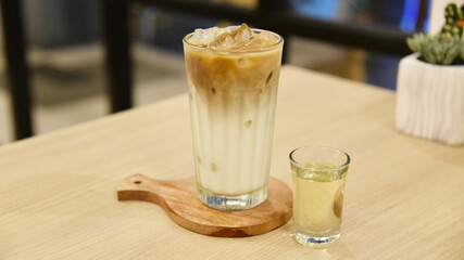 Milk and coffee with ice served on the table
