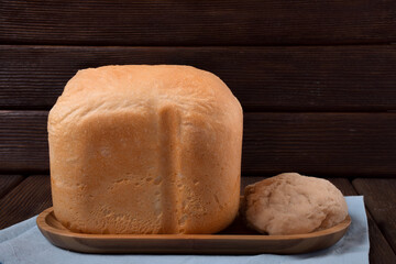 Hot homemade bread and wheat leaven. Baking from a bread machine. Minimalism.