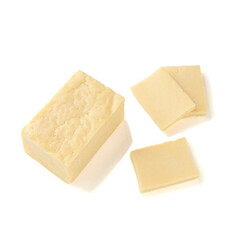 A piece of rectangular cheese without packaging. Several pieces have been cut off. View from above. White background. Isolated.