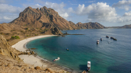 Beautiful bay view with boats at mountainous Padar island, Komodo National Park, Flores, East Nusa Tenggara, Indonesia