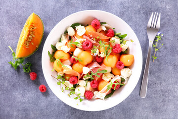 melon salad with mozzarella,  ham and raspberry