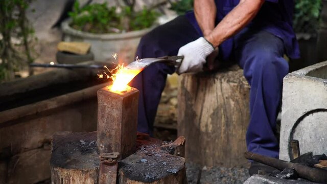The sparks produced by the ancient forging.
Old metal forming. Creating ancient crafts using objects from wrought iron or steel.