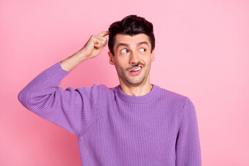 Photo of charming unsure young man dressed purple pullover forget something finger head isolated...