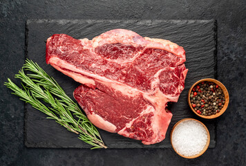 raw T-Bone Beef Steak on stone background