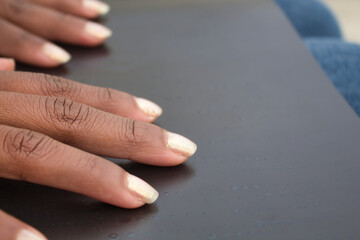 Obraz na płótnie Canvas Detail of african american woman´s hands reading braille in a black book.
