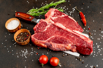 raw T-Bone Beef Steak on the knife on stone background
