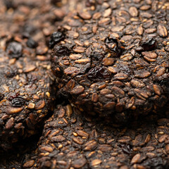 Dark Chocolate Cookies, Oatmeal Raisin Cookies. Sweet pastry background or texture. Homemade dessert with dried grapes. Oatmeal baked goods, cereal products. Close up shot. Square format. Soft focus.