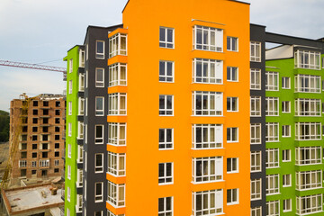 Aerial view of city residential area with high apartment buildings under construction.