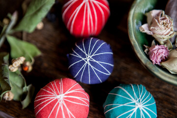  4 colorful balls on the table and dry roses on a plate