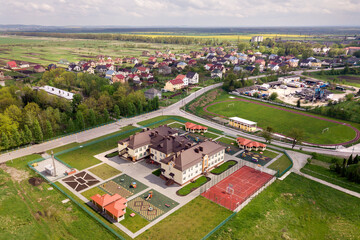 Fototapeta na wymiar Aerial view of new prescool building in residential rural area.