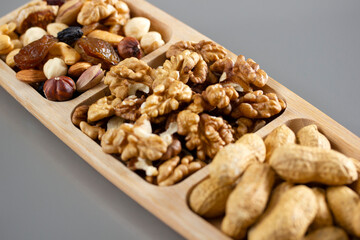 Mixed nuts in a bamboo plate. Healthy food concept.