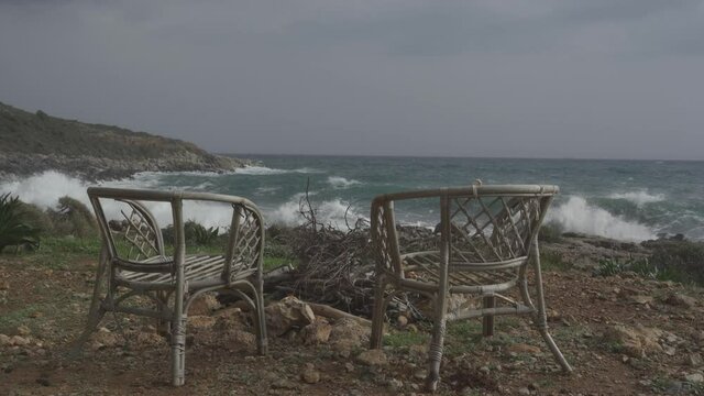 Two Wooden Chairs And Fireplace In Front Of The Ocean, Peloponnes, Greece