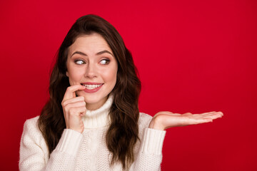 Photo of nice optimistic brunette lady look empty space wear white sweater isolated on vivid red color background