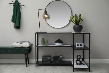 Hallway with stylish console table and mirror. Interior design