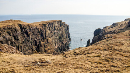 Three Maidens rock formations at the ocean on Isle of Skye in northern Scotland.