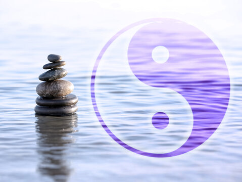 Stack of stones in water and Ying Yang symbol. Feng Shui philosophy