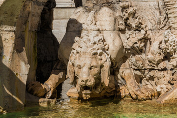 Fototapeta na wymiar The king of the jungle. Crouching lion marble statue in Navona Square fountain in Rome (17th century)