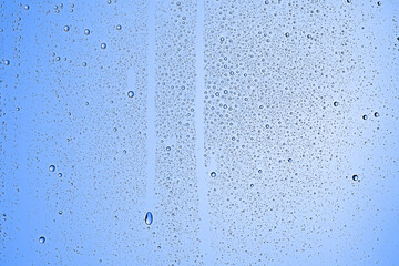 fresh drops background blue glass / wet rainy background, water drops transparent glass blue