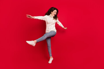 Fototapeta na wymiar Full length photo of excited sweet young lady wear collar pullover dancing jumping high isolated red color background
