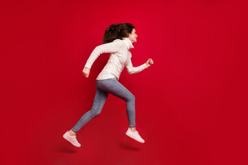 Fototapeta na wymiar Full length photo of cute purposeful young lady wear collar pullover jumping high running isolated red color background