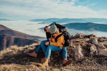 Fototapeta premium happy couple man and woman tourist at top of mountain during a hike in summer