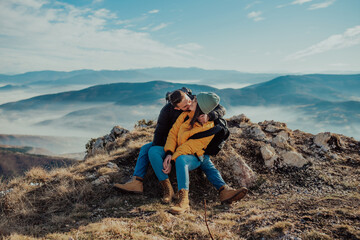 happy couple man and woman tourist at top of mountain during a hike in summer