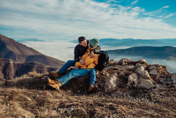 Fototapeta premium happy couple man and woman tourist at top of mountain during a hike in summer