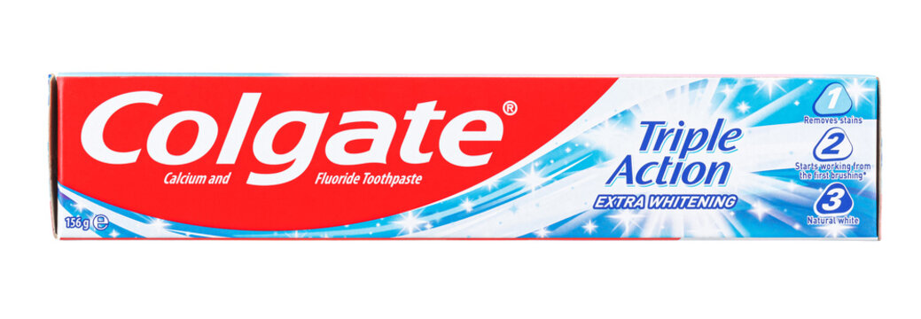 Moscow, Russia - March 27, 2021: Front view of cardboard packaging of Colgate Triple Action Extra Whitening toothpaste with english inscription on front side isolated on white background