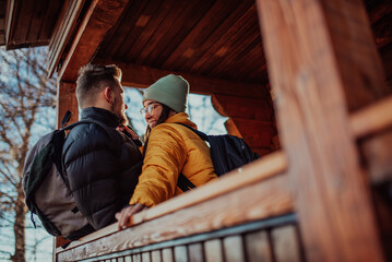 Loving man and woman standing in their cottage room balcony