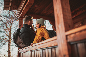 Loving man and woman standing in their cottage room balcony