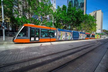 Fototapeta na wymiar Tram moving through George St at Circular Quay in Sydney NSW Australia