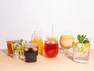 Various refreshing non-alcoholic drinks in glasses with ice.