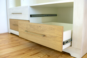 Close up of wooden drawer in contemporary cupboard cabinet.