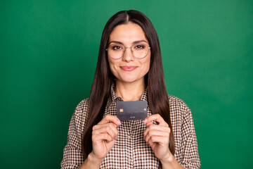 Photo of lady hands hold debit plastic card wear eyeglasses checkered shirt isolated green color background