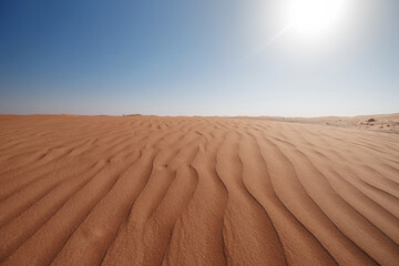 Sunset over the sand dunes in the desert.