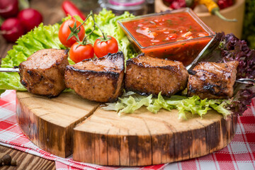 Delicious juicy skewered meat or shish kebabs on skewers of pork tenderloin