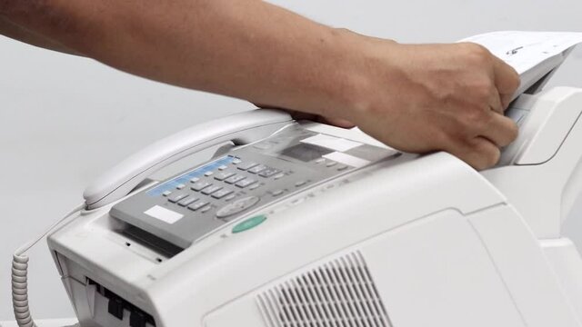 hand man are using a fax machine in the office, equipment for data transmission
