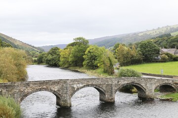 Fototapeta premium An ancient bridge across the River Dee at Carrog, Wales, UK.