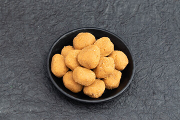 Auspicious Indian Mathura Peda Or Pede Offered As Prasad To Hindu God Is Mithai Made Of Mawa Khoya Makhan Meetha Gud Doodh Khoa Malai Mava Gur Served In Plate. Isolated On Black Background