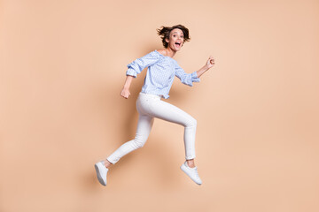 Fototapeta na wymiar Photo portrait profile of crazy girl running screaming jumping up isolated on pastel beige colored background