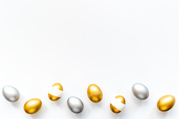 Silver and golden eggs isolated on white background. Easter decoration background. Top view
