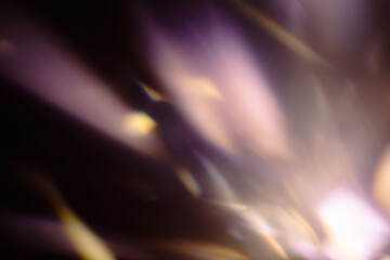 Blur colorful warm rainbow light leaks on black background with dust texture. Defocused abstract damaged scratched retro film analog effect for using over photos as overlay or screen filter