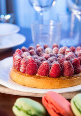 Tart with fresh raspberries on a plate